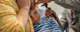 Petit garçon souffrant d'une otite chez le médecin